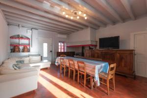 a living room with a couch and a table at La Maison Du Soleil L'aulhère in Oloron-Sainte-Marie