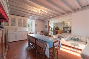 a living room with a table and a couch at La Maison Du Soleil L'aulhère in Oloron-Sainte-Marie
