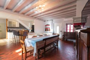 a kitchen and living room with a table and a couch at La Maison Du Soleil L'aulhère in Oloron-Sainte-Marie +30 photos
