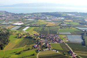 an aerial view of a village in a field at Beim Dorfbach - Die Hofchalets in Kressbronn am Bodensee