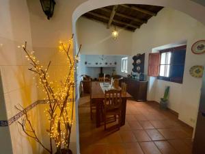 a kitchen and dining room with a table with lights at Casa d’ avó Lita in Falcoeiras