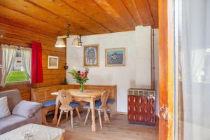 a living room with a table and a couch at Grashäusl in Grainau