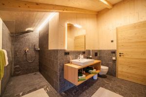 a bathroom with a sink and a shower and a toilet at Bergchalet Heidi und Peter in San Leonardo in Passiria +25 photos