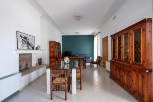 a kitchen with a table and a dining room at I Love Baia Verde spa in Baia Verde