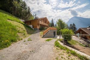 a dirt road leading to a house on a mountain at Bergchalet Heidi und Peter in San Leonardo in Passiria