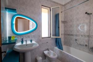 a bathroom with a sink and a mirror at I Love Baia Verde spa in Baia Verde +21 photos