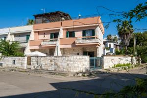 a house on the side of the street at I Love Baia Verde spa in Baia Verde