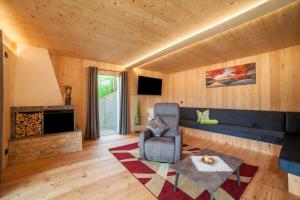 a living room with a chair and a fireplace at Bergchalet Heidi und Peter in San Leonardo in Passiria
