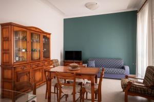 a living room with a table and a couch at I Love Baia Verde spa in Baia Verde