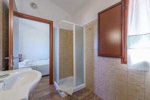 a bathroom with a shower and a white sink at Casa Mirto con piscina e vista mare in Aglientu +21 photos