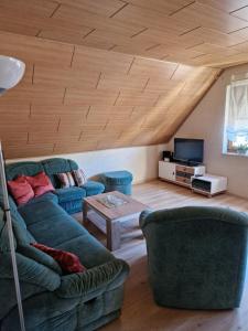 a living room with a couch and a table at Ferienwohnung Auenweg in Radebeul