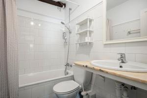 a bathroom with a sink and a toilet and a tub at Apartamento 1 Casa Las Indianas in Selores +15 photos