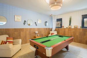 a living room with a pool table and a couch at Mountain View Villa in Bárig