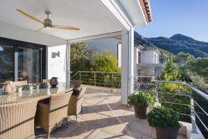 a patio with a table and chairs on a balcony at Mountain View Villa in Bárig