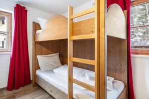 a bunk bed in a tiny room with a ladder at Good Life Top 3 in Saalbach-Hinterglemm