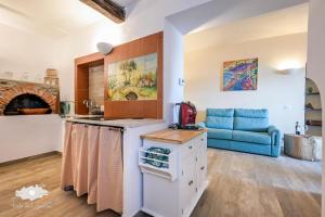 a kitchen with a blue couch in a room at Pieds Dans L'eau - Bogliasco in Bogliasco