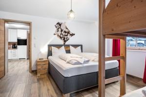 a bedroom with a bunk bed and a kitchen at Good Life Top 3 in Saalbach-Hinterglemm +27 photos