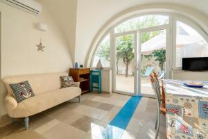 a living room with a couch and a table at Agrumeto sul mare in Ostuni