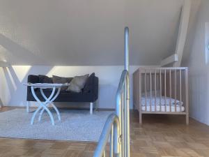 a living room with a couch and a crib at Oberneulander Gästehaus in Bremen