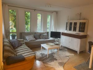 a living room with a couch and a table at Oberneulander Gästehaus in Bremen