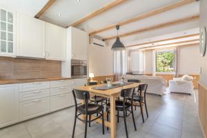 a kitchen with a wooden table and black chairs at Stathis Home in Exanthia