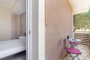 a room with a bed and a table and chairs at Stathis Home in Exanthia +19 photos