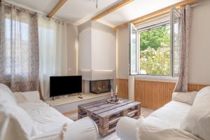 a living room with a couch and a tv at Stathis Home in Exanthia