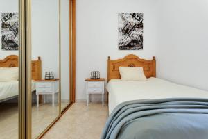 a bedroom with a bed and a mirror at Sueño in La Mata +11 photos