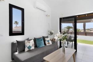 a living room with a couch and a table at Casa Luna Kingbed and Jacuzzi in Maspalomas