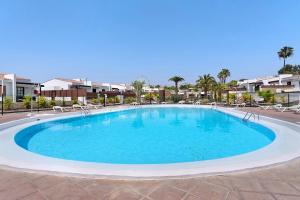 a large pool with blue water in a resort at Casa Luna Kingbed and Jacuzzi in Maspalomas