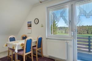 a dining room with a table and chairs and a window at Unterfalkenhof in Schramberg