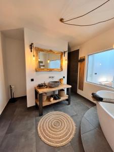 a bathroom with a sink and a tub and a mirror at Casa Storica Gardola in Tignale +31 photos