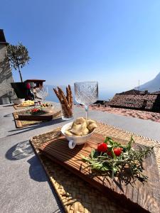 a table with a bowl of food and a wine glass at Casa Storica Gardola in Tignale