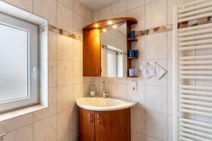 a bathroom with a sink and a mirror at Haus Waldblick in Bad Berleburg +37 photos