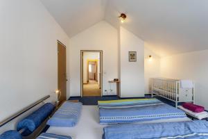 a room with two beds and a hallway at Haus Waldblick in Bad Berleburg
