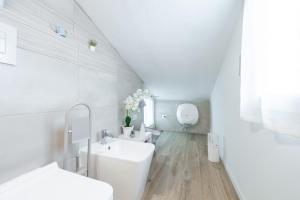a white bathroom with a sink and a toilet at Al Chiaro di Luna in Decimomannu +16 photos