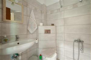 a white bathroom with a sink and a toilet at Elia home kanali in Kanali +24 photos