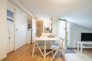 a dining room with a table and chairs and a television at Al Chiaro di Luna in Decimomannu