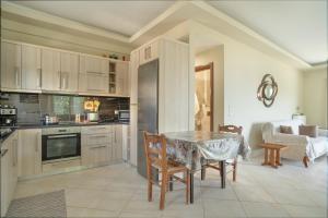 a kitchen with a table and a dining room with a couch at Elia home kanali in Kanali
