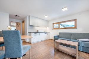 a living room with a couch and a table at App Dolomiten Villa Colli in Valdaora