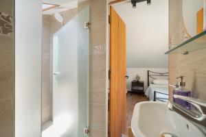 a bathroom with a sink and a shower and a bed at Nikiana hideaway in Nikiana +29 photos