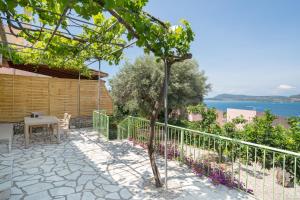 a patio with a table and a tree at Nikiana hideaway in Nikiana