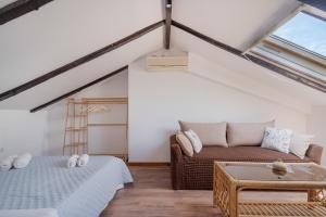 a attic room with a bed and a couch at Nikiana hideaway in Nikiana