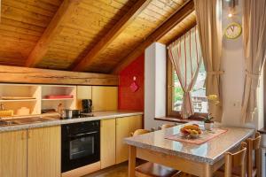 a kitchen with a table and a counter top at Residence Bonetti in Rabbi
