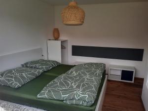 a bedroom with two beds and a small table at Ferienwohnung Im Eyachtal in Albstadt