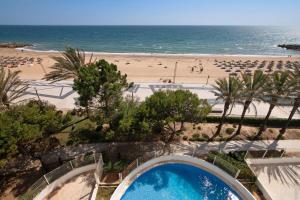 a view of a beach with a swimming pool at Beachfront Apartment T2 in Quarteira