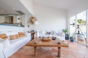 a living room with a white couch and a table at Beachfront Apartment Port de Soller in Sóller +16 photos