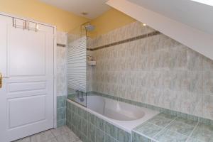 a bathroom with a tub and a sink at Ty Gwen in Ploeren +16 photos