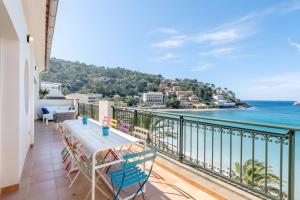a balcony with a view of the ocean at Beachfront Apartment Port de Soller in Sóller