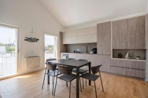 a kitchen with a dining room table and chairs at Luxury Home in Bari